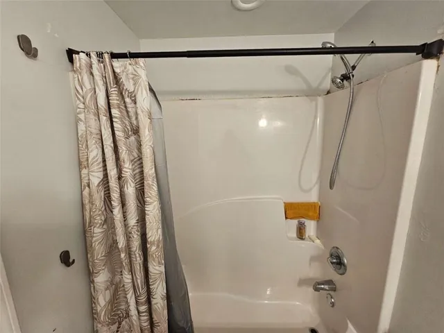 a bathroom with a shower and a tub