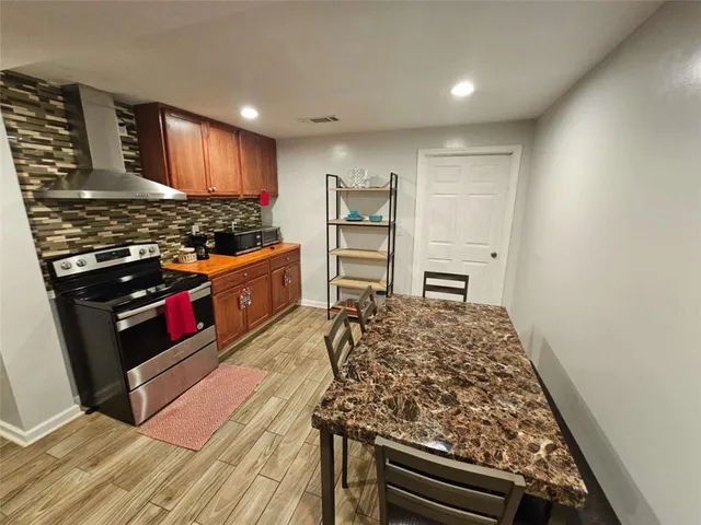 a kitchen with wooden cabinets and a stove top oven
