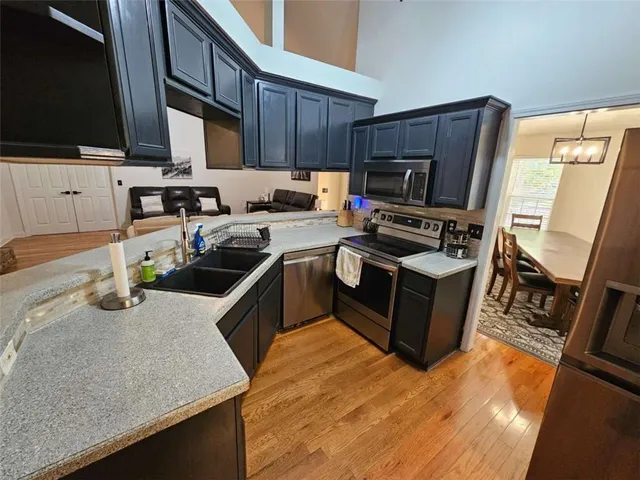 a kitchen with a stove a sink and a microwave