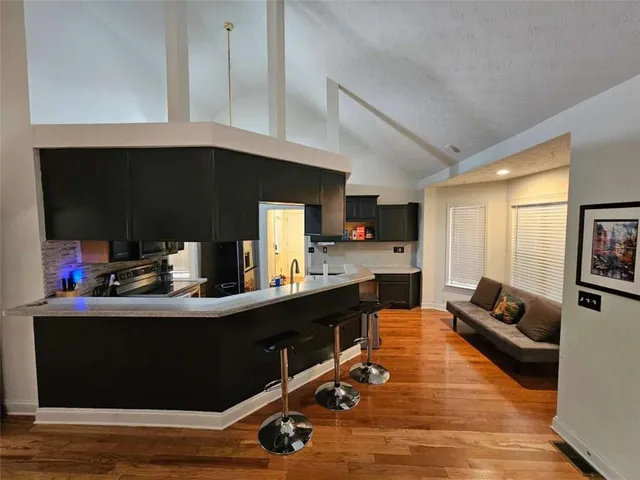 a kitchen with a sink appliances and cabinets