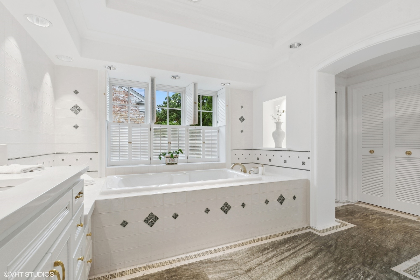 1224 Ridgewood Drive Northbrook, IL 60062 - Photo 17 of 34 a spacious bathroom with a double vanity sink mirror and