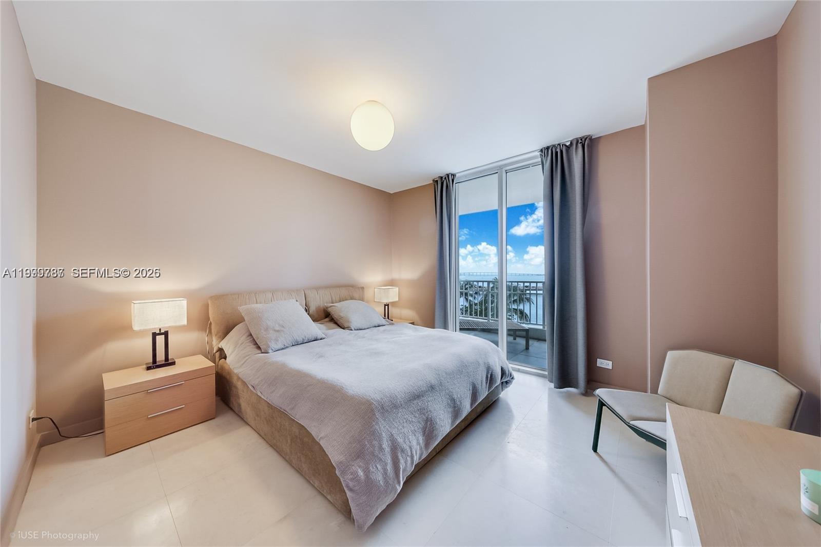 701 Brickell Key Boulevard, Unit 503 Miami, FL 33131 - Photo 13 of 25 a bedroom with a large bed and a couch