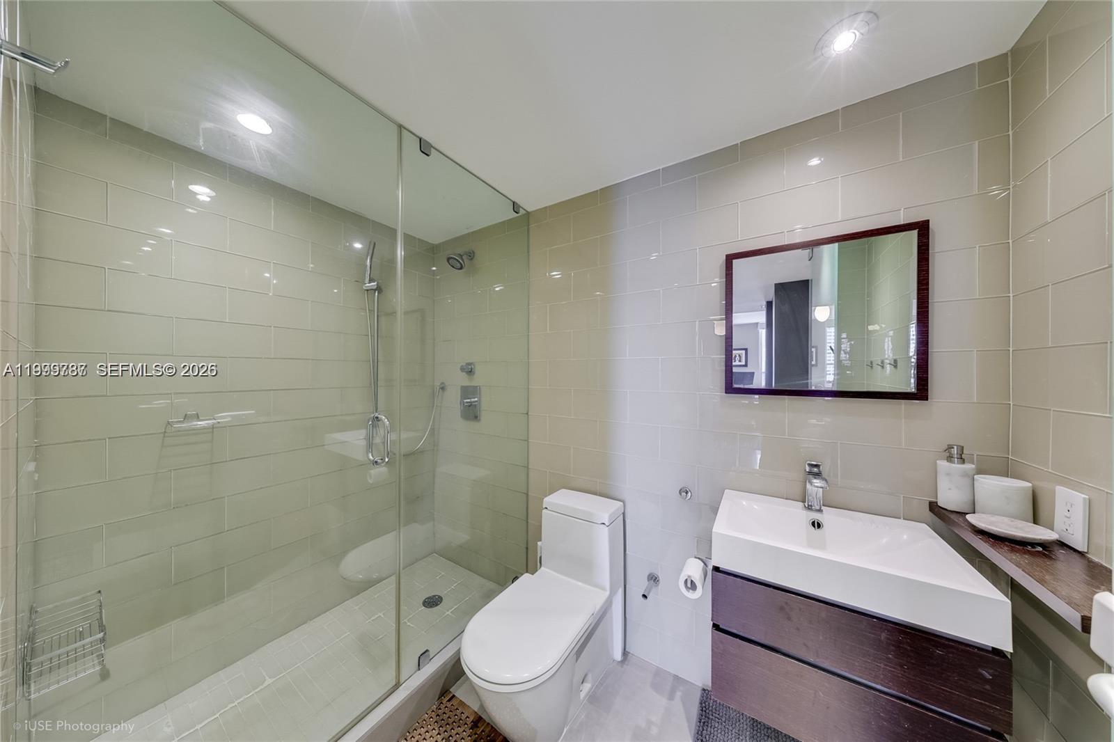 701 Brickell Key Boulevard, Unit 503 Miami, FL 33131 - Photo 14 of 25 a bathroom with a sink a toilet and shower