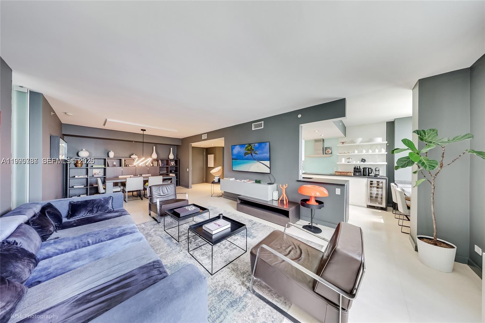 701 Brickell Key Boulevard, Unit 503 Miami, FL 33131 - Photo 2 of 25 a living room with furniture and a flat screen tv
