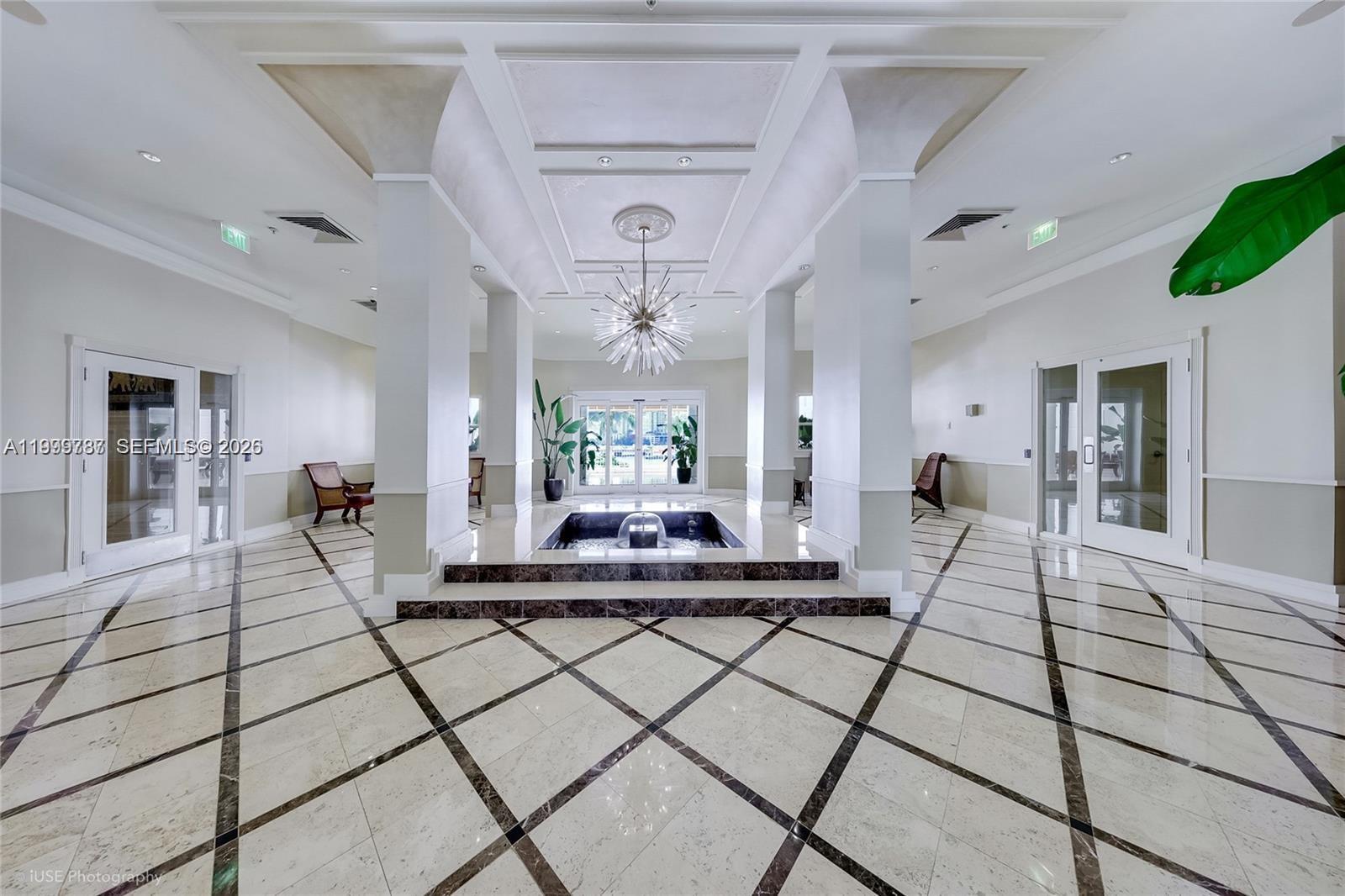 701 Brickell Key Boulevard, Unit 503 Miami, FL 33131 - Photo 23 of 25 a living room with furniture and a chandelier