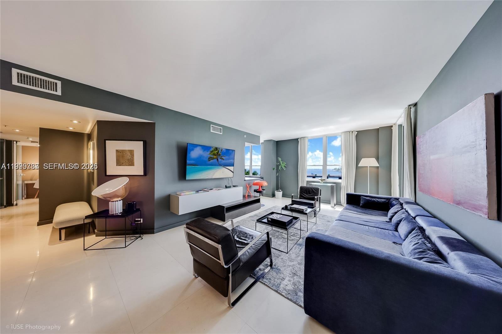701 Brickell Key Boulevard, Unit 503 Miami, FL 33131 - Photo 4 of 25 a living room with furniture and a flat screen tv
