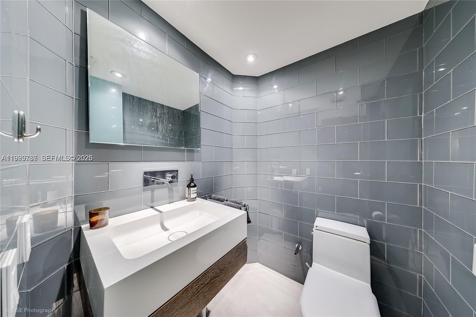 701 Brickell Key Boulevard, Unit 503 Miami, FL 33131 - Photo 7 of 25 a bathroom with a sink toilet and mirror
