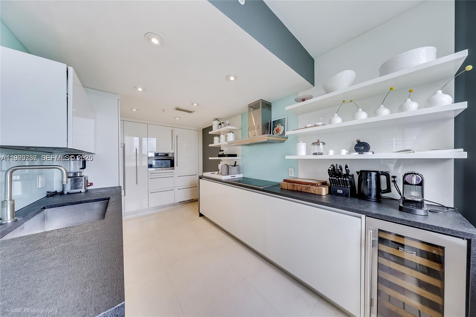 701 Brickell Key Boulevard, Unit 503 Miami, FL 33131 - Photo 8 of 25 a kitchen with granite countertop lots of stainless steel appliances granite countertop a sink and cabinets