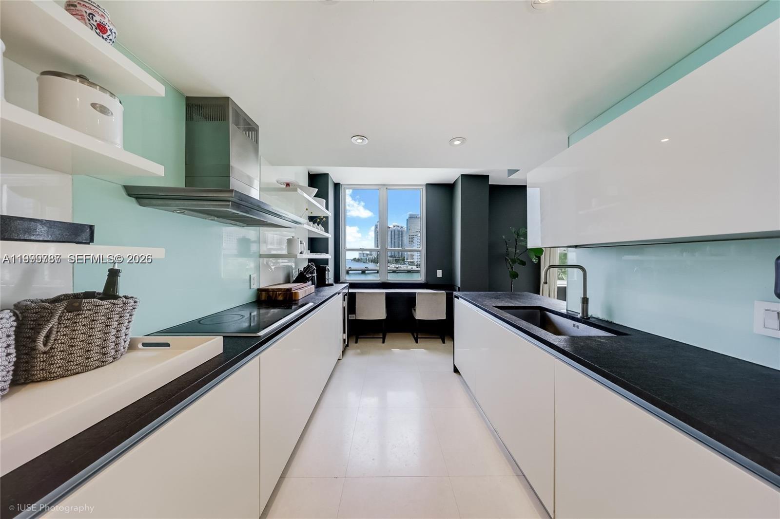 701 Brickell Key Boulevard, Unit 503 Miami, FL 33131 - Photo 9 of 25 a kitchen with stainless steel appliances a sink stove and cabinets