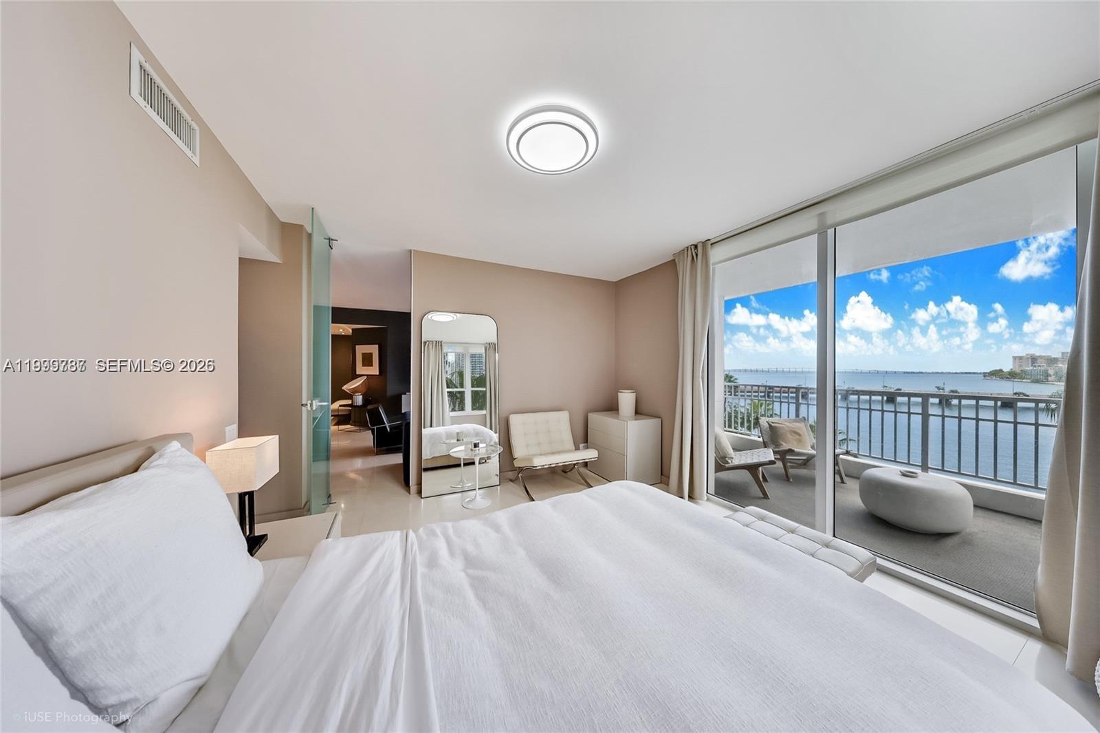 701 Brickell Key Boulevard, Unit 503 Miami, FL 33131 - Photo 10 of 25 a bedroom with a bed and large glass window