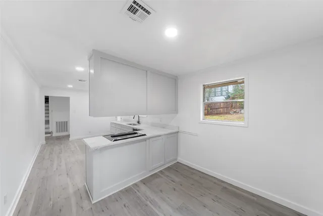 a kitchen with a sink and cabinets