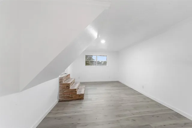 a view of an empty room and a window