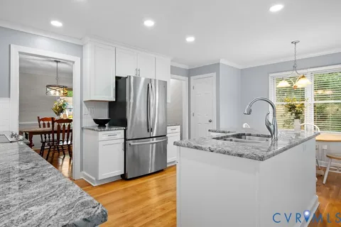 a kitchen with stainless steel appliances granite countertop a sink refrigerator and microwave