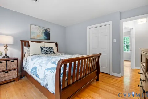 a bed room with a bed and a chair