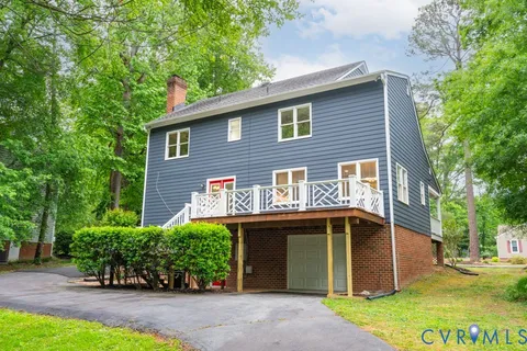 a view of house with outdoor space and garden