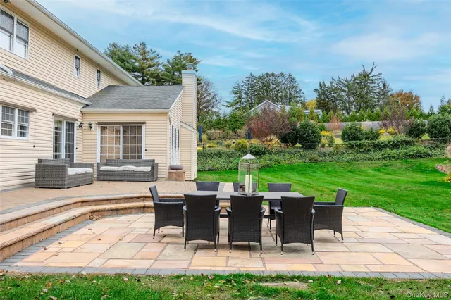 a view of a dining room with furniture a chandelier and wooden floor