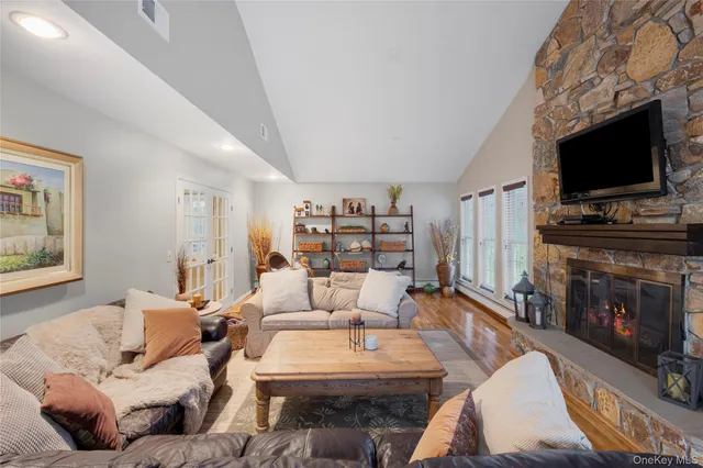 a view of a room with furniture and wooden floor