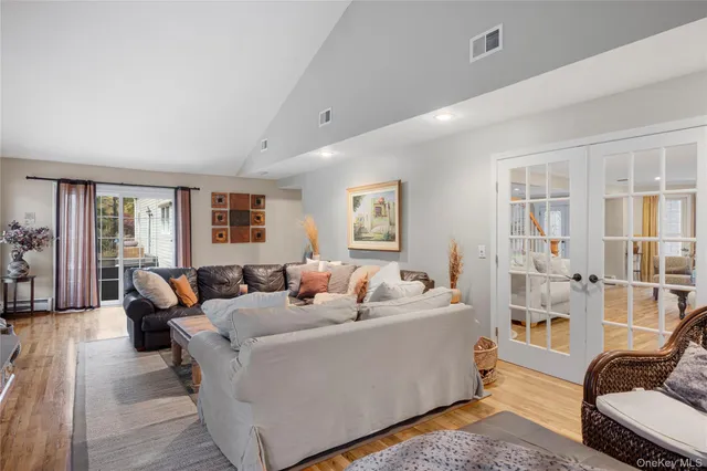a bathroom with a sink a toilet and shower a mirror
