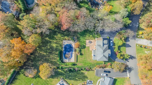 a view of a house with a big yard and large trees