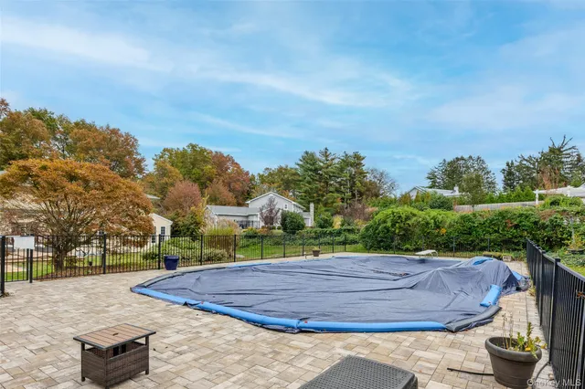 a view of a dining room with furniture a chandelier and wooden floor