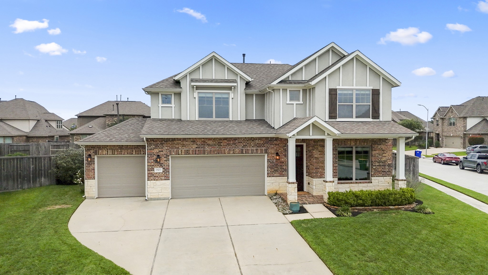 Welcome to 7502 Windsor Park Court — Craftsman-inspired architecture, an oversized corner lot, and a 3-car garage create a memorable first impression, while the covered front porch offers a warm welcome before the tour continues inside.