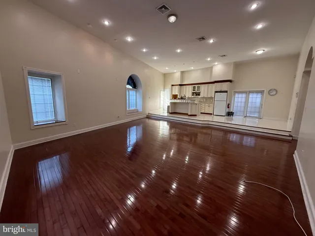 a view of a kitchen with sink and wooden floor