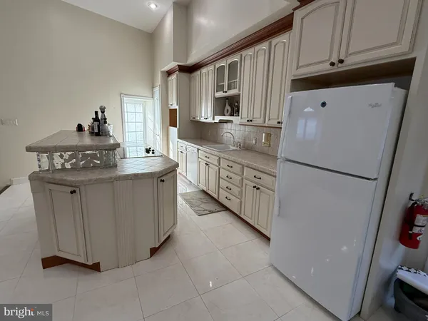 a kitchen with stainless steel appliances granite countertop a stove a refrigerator and a cabinets