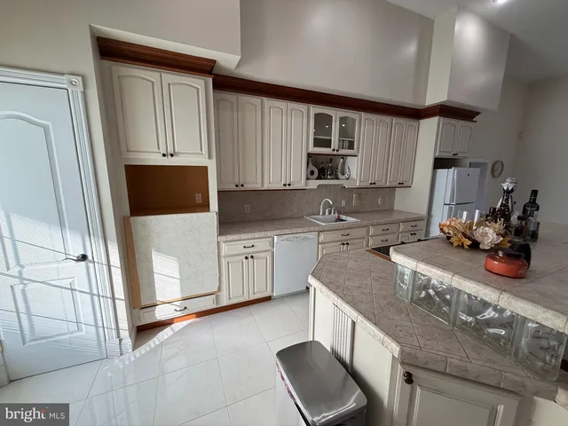 a kitchen with stainless steel appliances granite countertop a sink a stove a microwave a sink and cabinets
