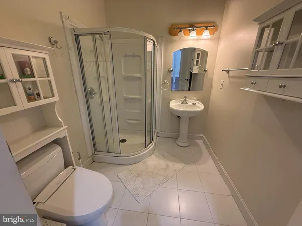 a bathroom with a sink a toilet and mirror