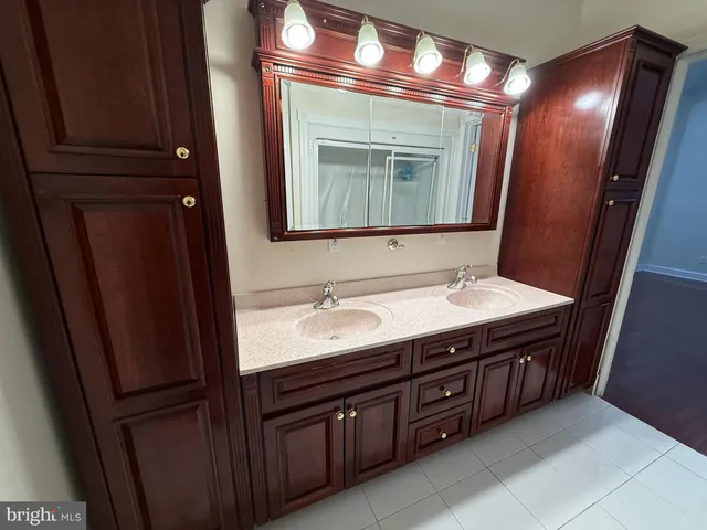 a bathroom with a double vanity sink and a mirror