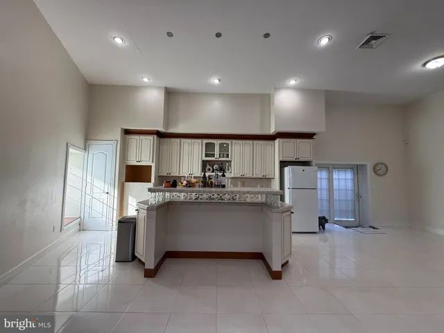 a kitchen with counter top space and windows