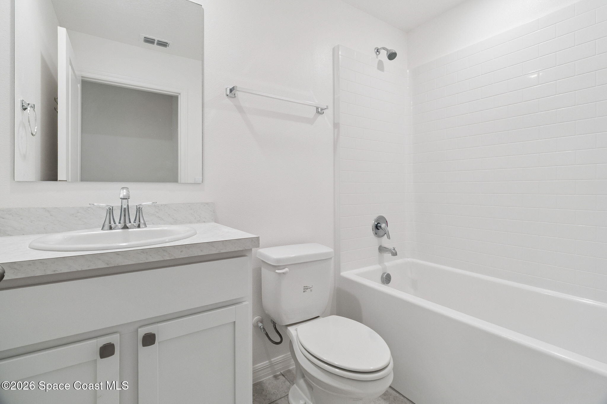 700 Tejon Avenue Southwest Palm Bay, FL 32908 - Photo 13 of 33 a bathroom with a sink toilet vanity and shower