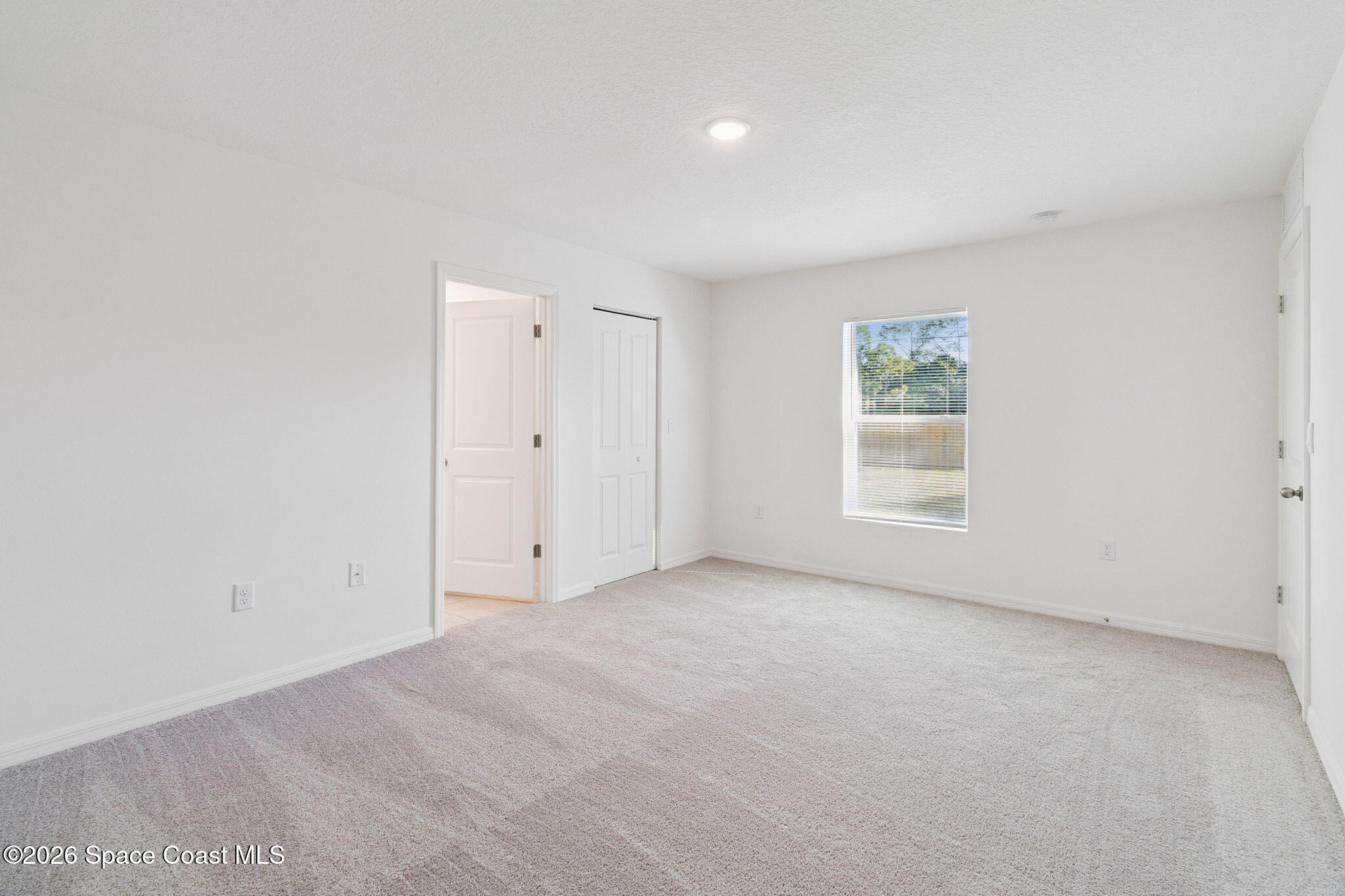 700 Tejon Avenue Southwest Palm Bay, FL 32908 - Photo 14 of 33 an empty room with windows and closet