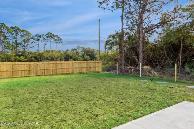 an aerial view of a house with a yard and lake view