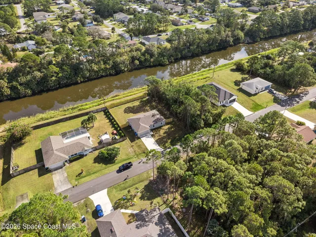 an aerial view of a houses with a lake view
