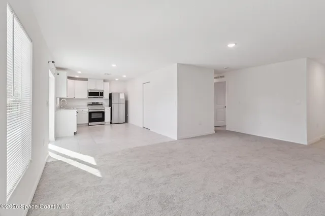 a view of kitchen and refrigerator