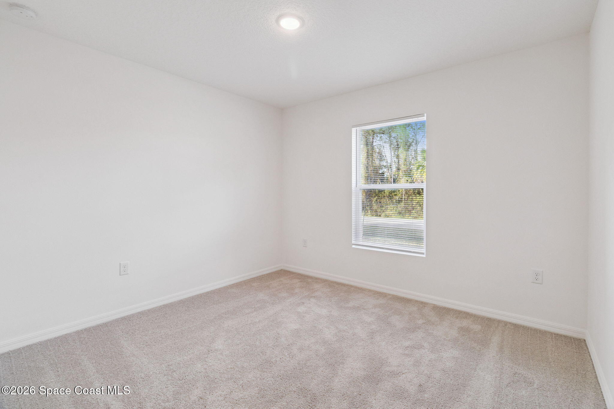 700 Tejon Avenue Southwest Palm Bay, FL 32908 - Photo 7 of 33 an empty room with a window