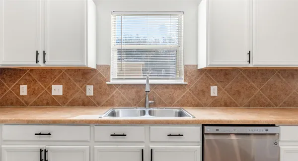 a kitchen with a sink and a window