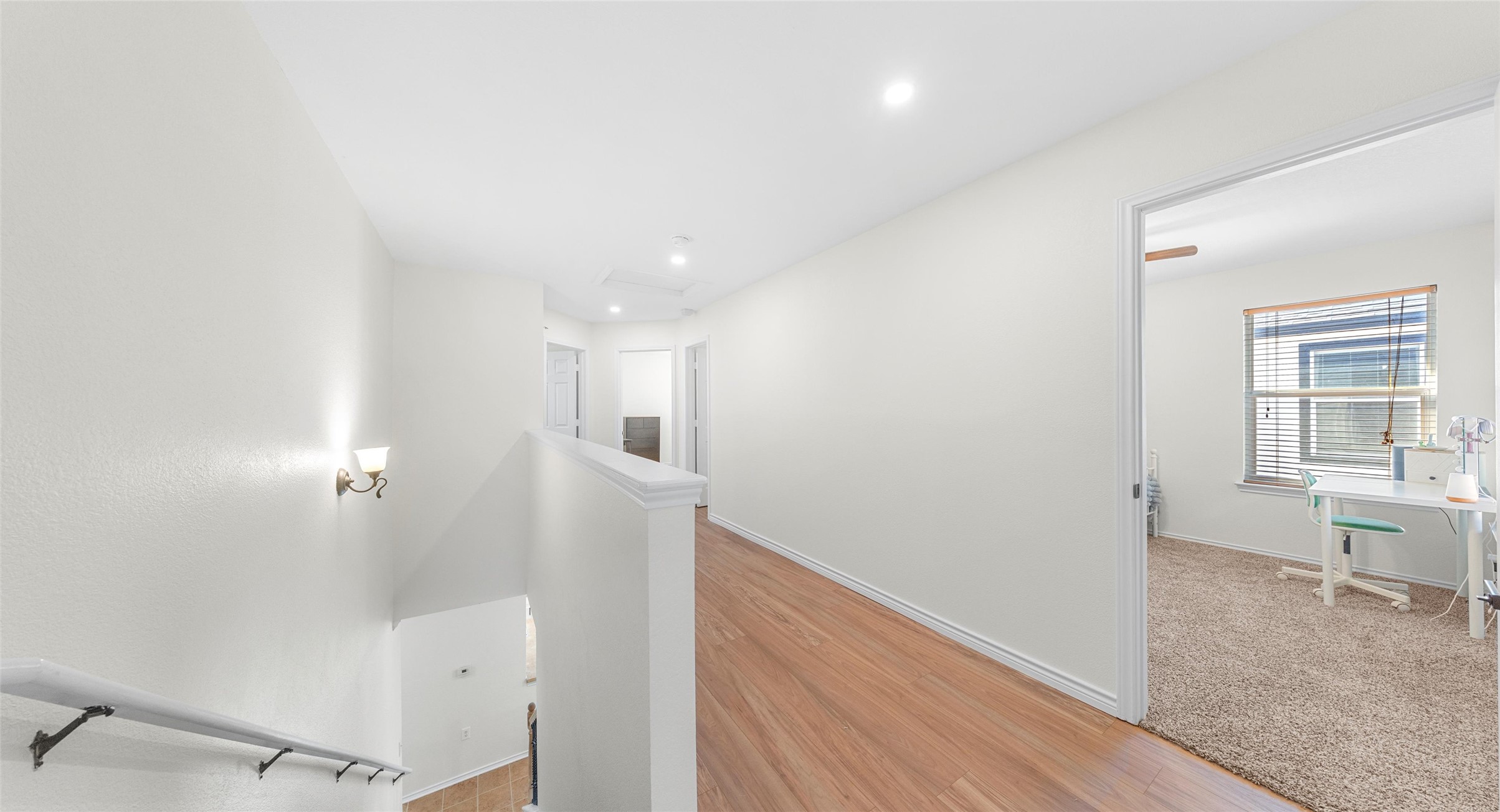8613 Wiley Way Austin, TX 78747 - Photo 16 of 33 Hall featuring an upstairs landing, light wood-style floors, and recessed lighting