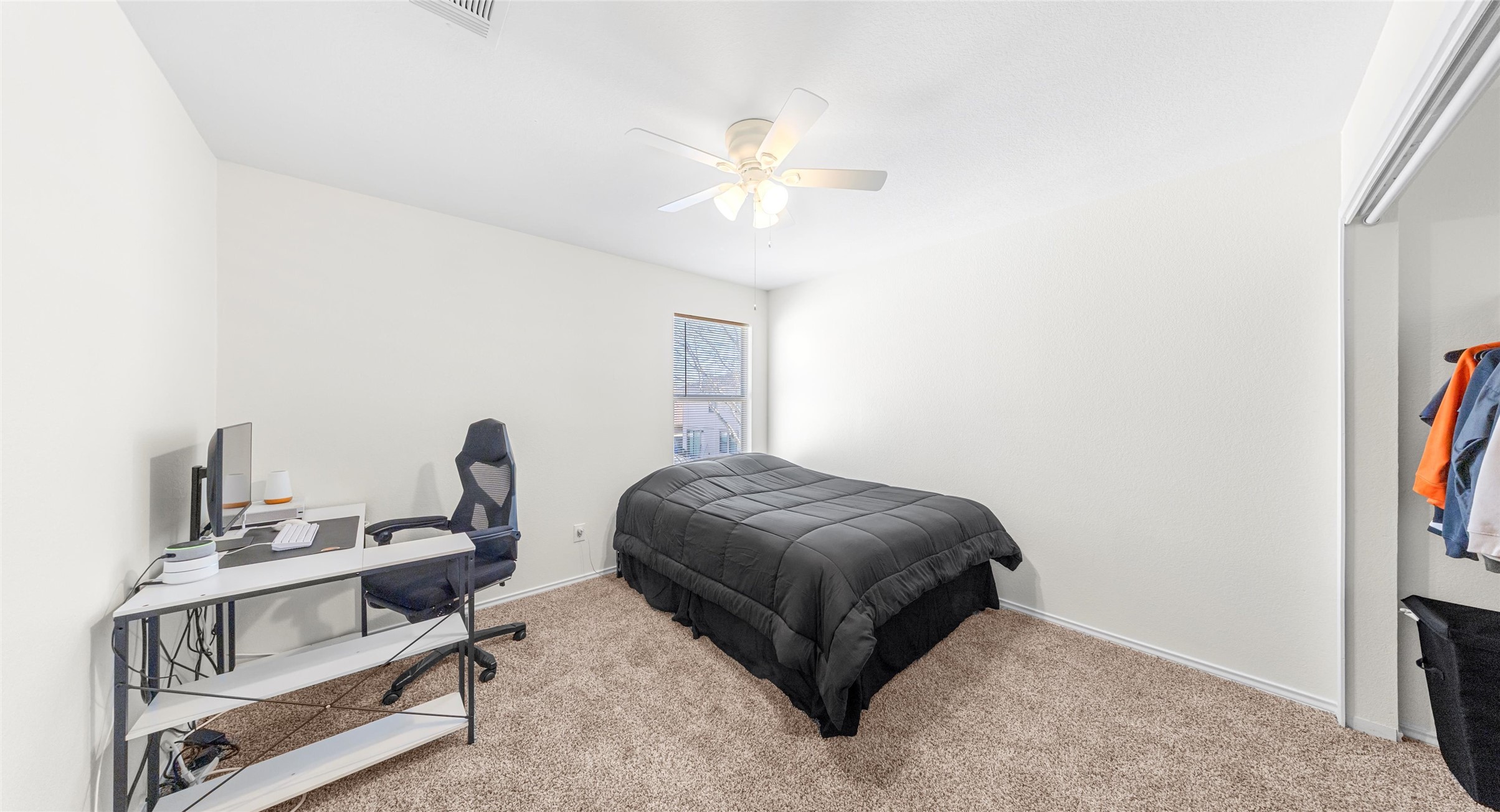 8613 Wiley Way Austin, TX 78747 - Photo 26 of 33 Bedroom featuring a desk, ceiling fan, and carpet flooring