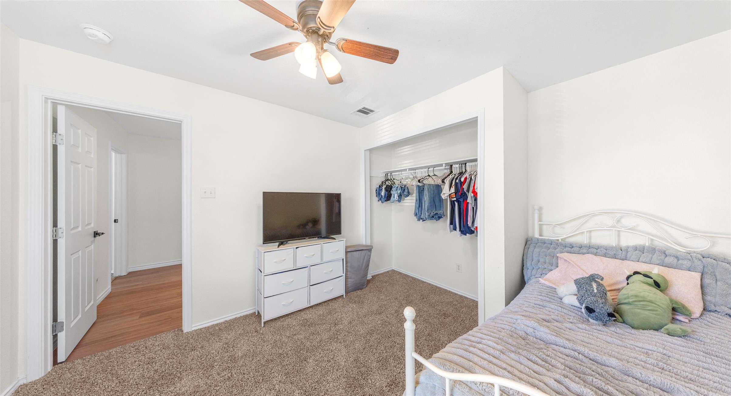 8613 Wiley Way Austin, TX 78747 - Photo 28 of 33 Carpeted bedroom featuring a closet and a ceiling fan