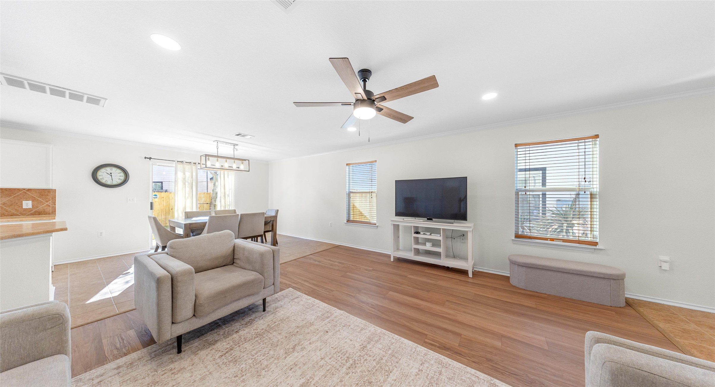 8613 Wiley Way Austin, TX 78747 - Photo 5 of 33 Living area with a ceiling fan, light wood-style flooring, recessed lighting, and crown molding