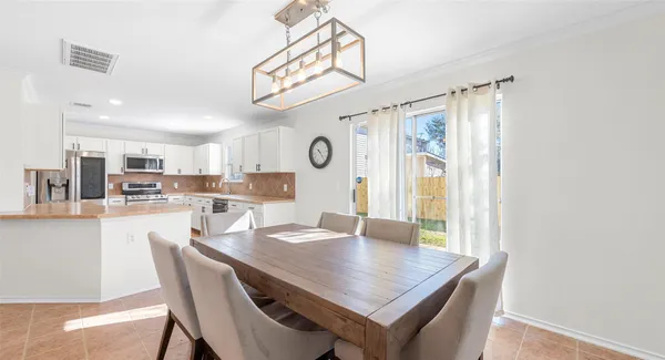 a view of a dining area with furniture and a chandelier