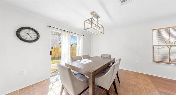 a view of a dining room with furniture and window