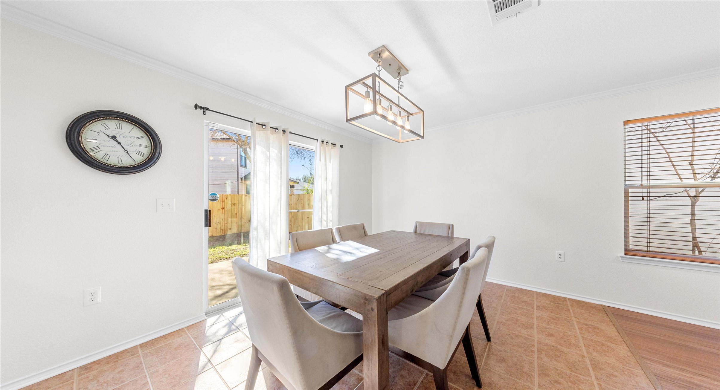 8613 Wiley Way Austin, TX 78747 - Photo 7 of 33 Dining area with crown molding, hanging lights, and light tile patterned flooring