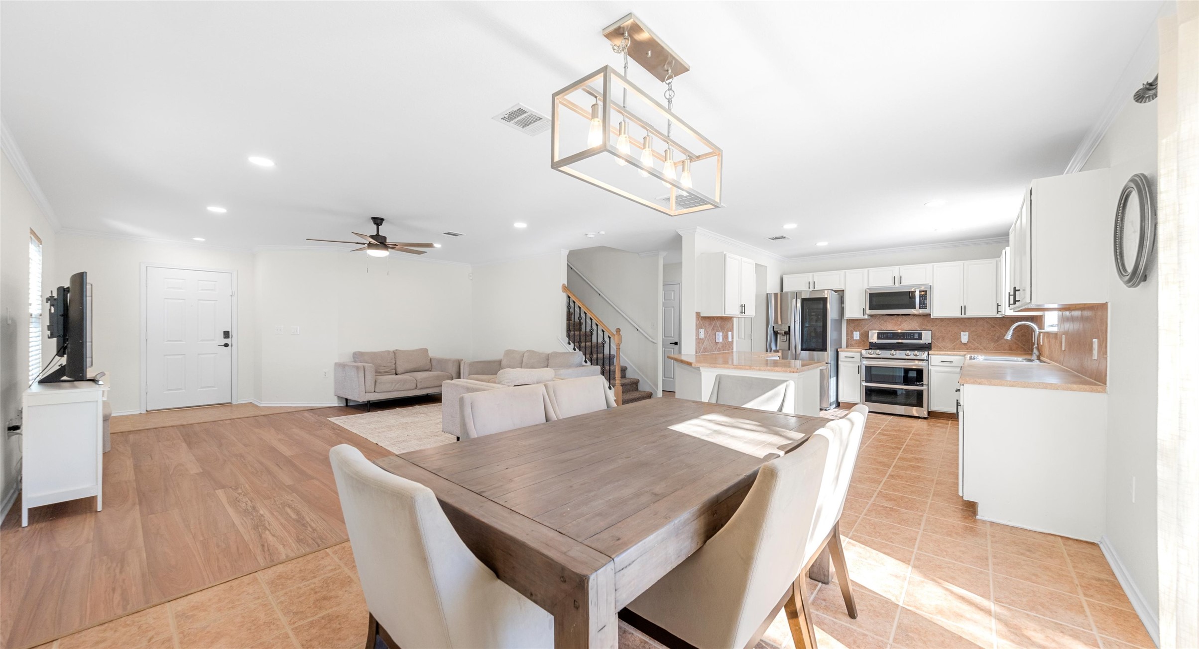 8613 Wiley Way Austin, TX 78747 - Photo 8 of 33 Dining area featuring ceiling fan, recessed lighting, light tile patterned flooring, and ornamental molding