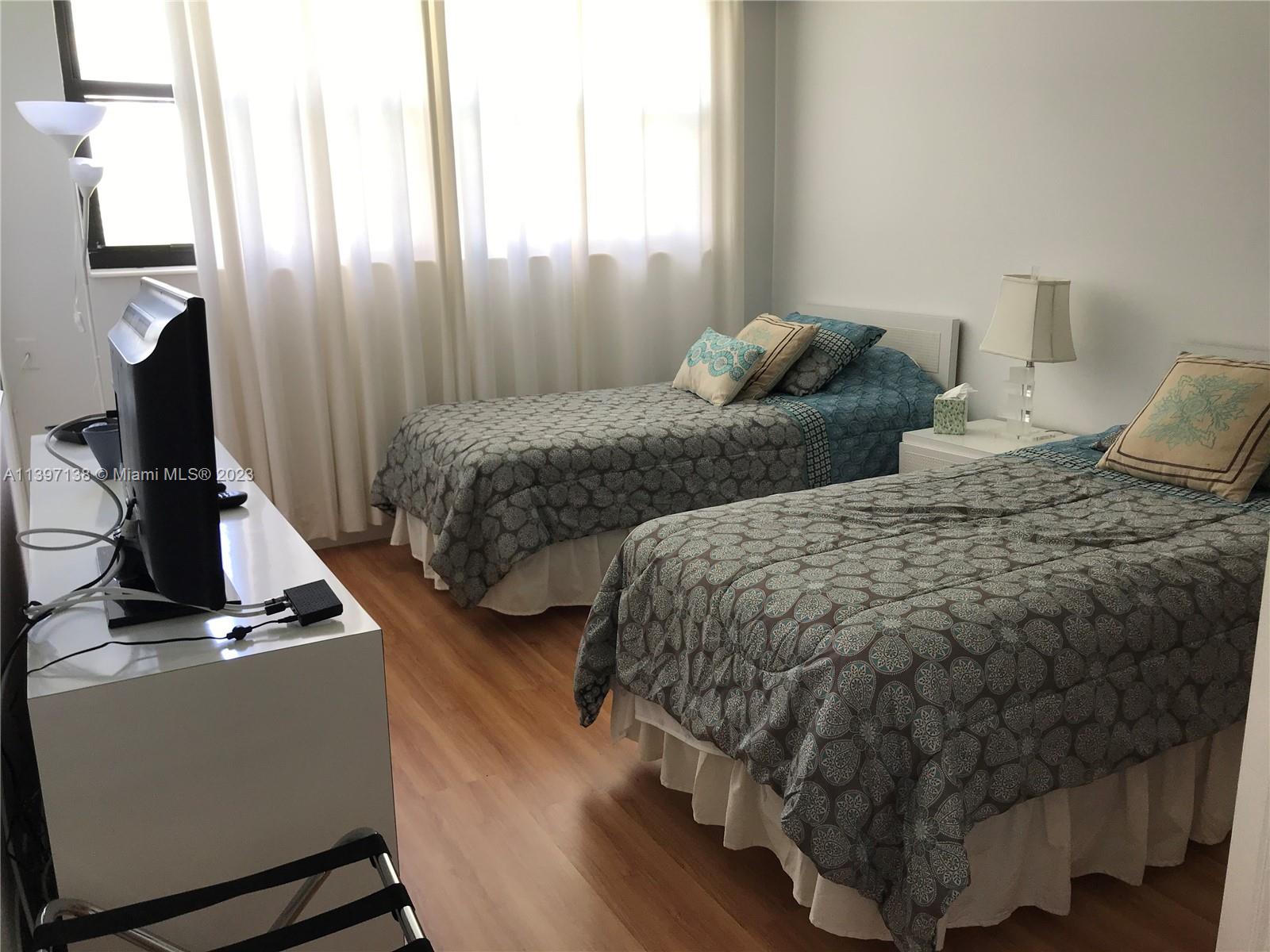 Bonaventure Weston, FL 33326 - Photo 12 of 14 a bedroom with two beds and wooden floor