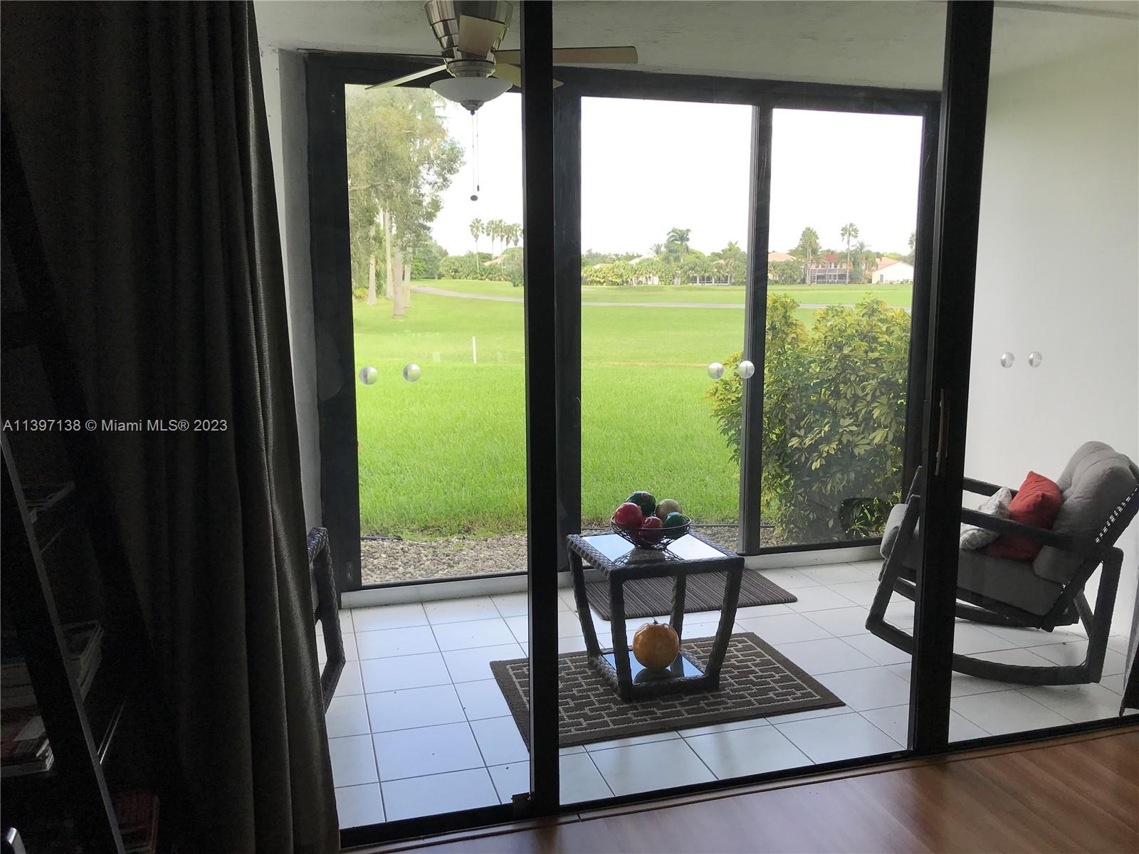 Bonaventure Weston, FL 33326 - Photo 2 of 14 a living room with glass door and furniture