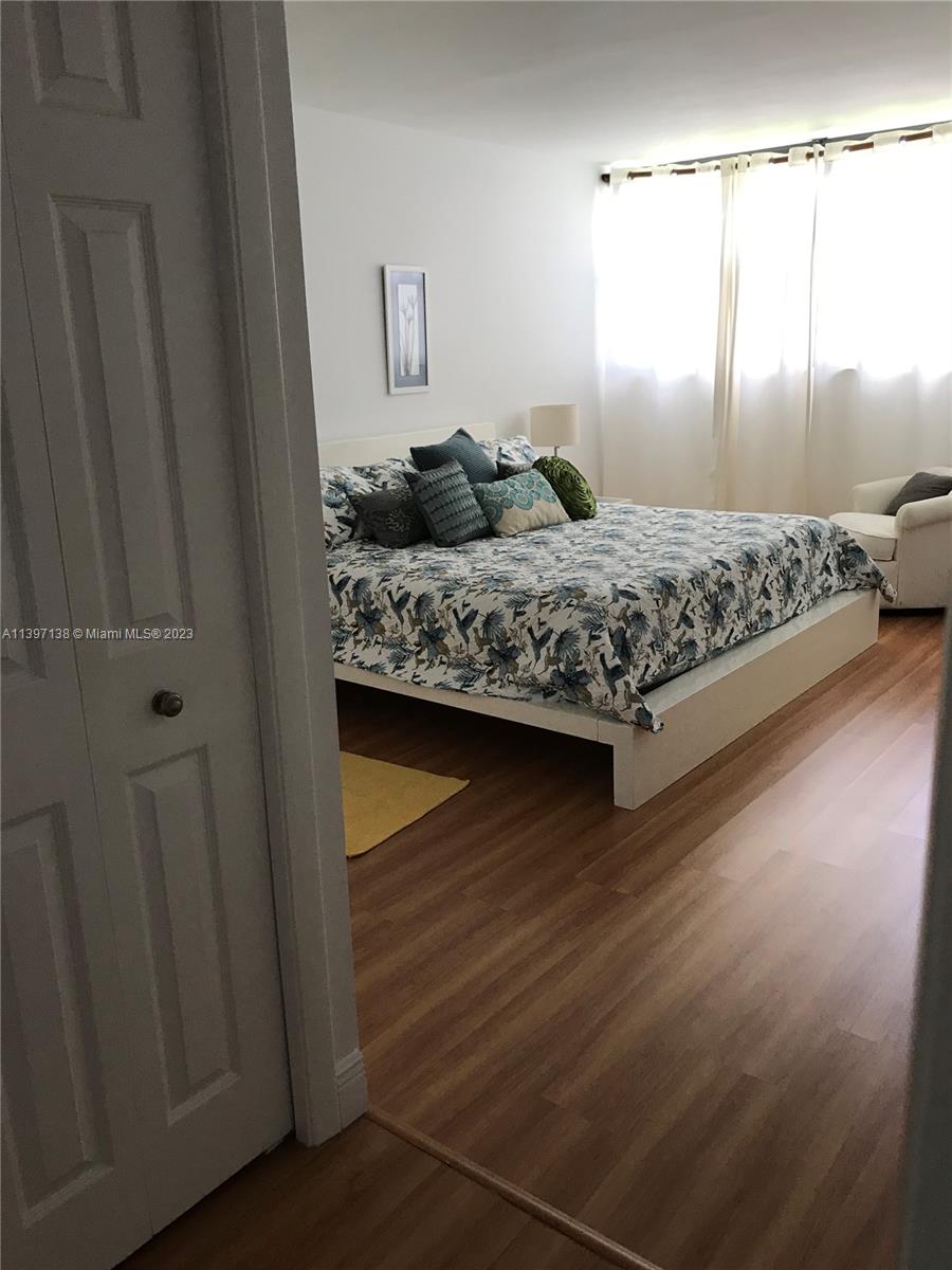 Bonaventure Weston, FL 33326 - Photo 10 of 14 a bedroom with a bed and wooden floor