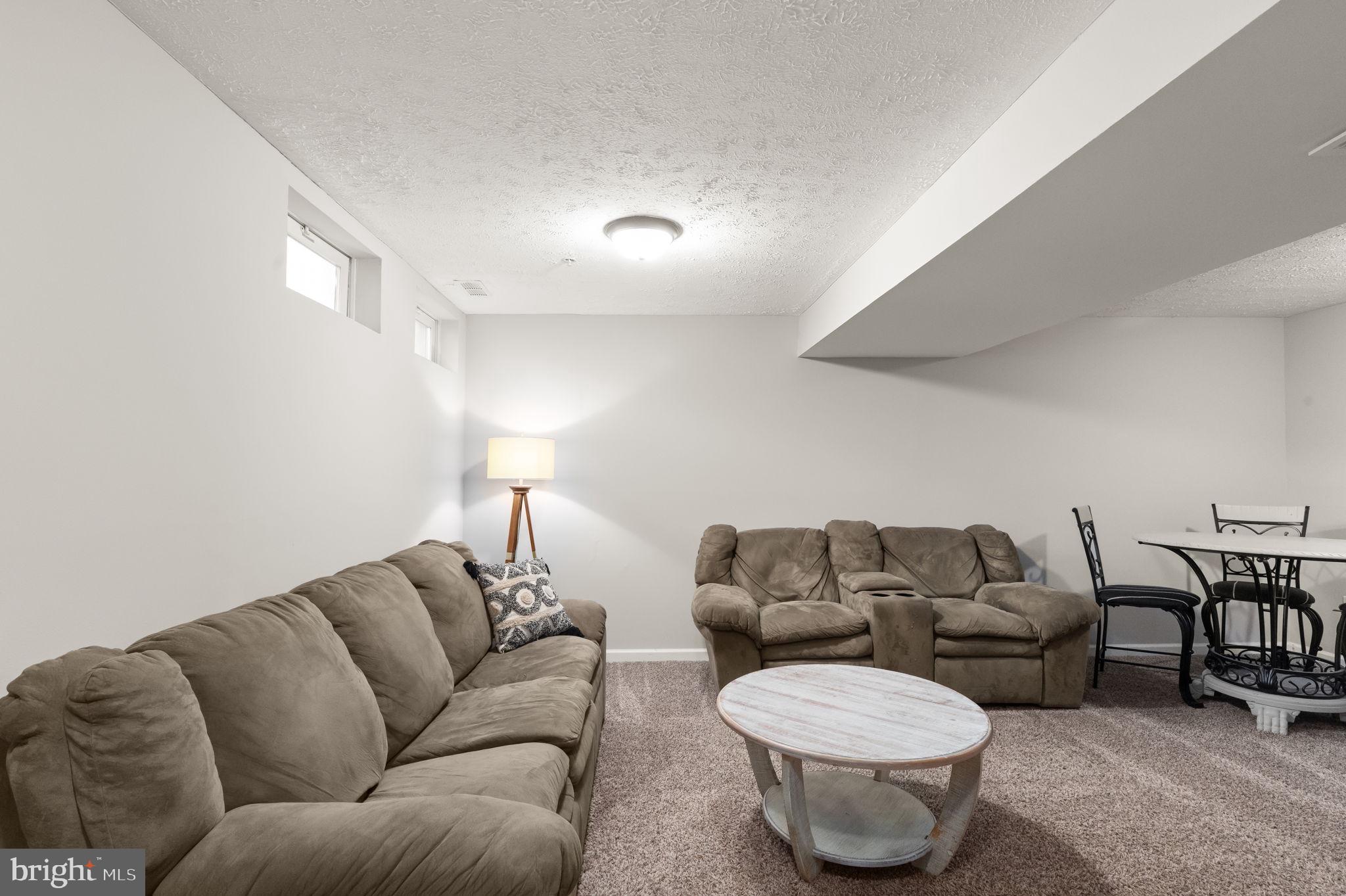 488 Crestridge Way Abingdon, MD 21009 - Photo 18 of 22 a living room with furniture a rug and a lamp